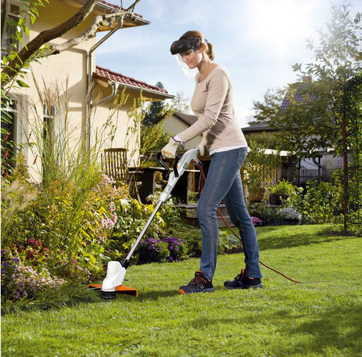 live action image of Stihl electric brushcutter in use