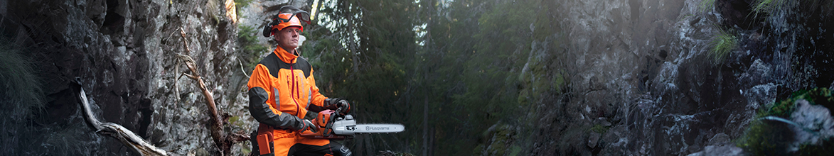 Man with Husqvarna Chainsaw wearing Protective Clothing