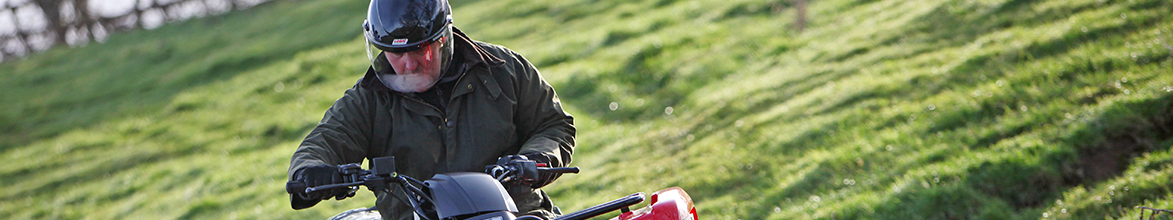 Man on quad wearing safety helemt