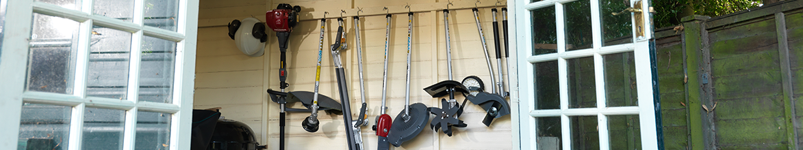 Arrangement of Honda Versatool hanging in shed